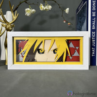 Boite lumineuse Edward Elric FMA éteinte, cadre blanc fond jaune avec cheveux blonds et symboles alchimie triangulaires