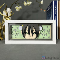 Boite lumineuse Toph Avatar éteinte, cadre blanc fond vert pâle avec silhouette anime et motifs terre découpés