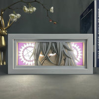 Boite lumineuse Undertaker Black Butler allumée en rose, roues dentées et étoiles lumineuses encadrant le visage sinistre