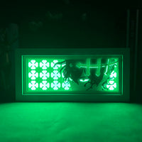 Boite lumineuse Yuno illuminée vert intense dans l'obscurité, trèfles et croix Black Clover luminescents visibles