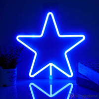 Néon LED étoile bleu vif à cinq branches posé sur un bureau, reflet sur la surface, décoration chambre moderne